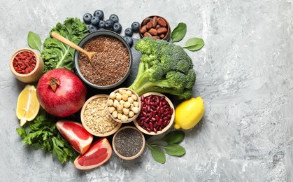 Photo of Different superfood products on grey table, flat lay