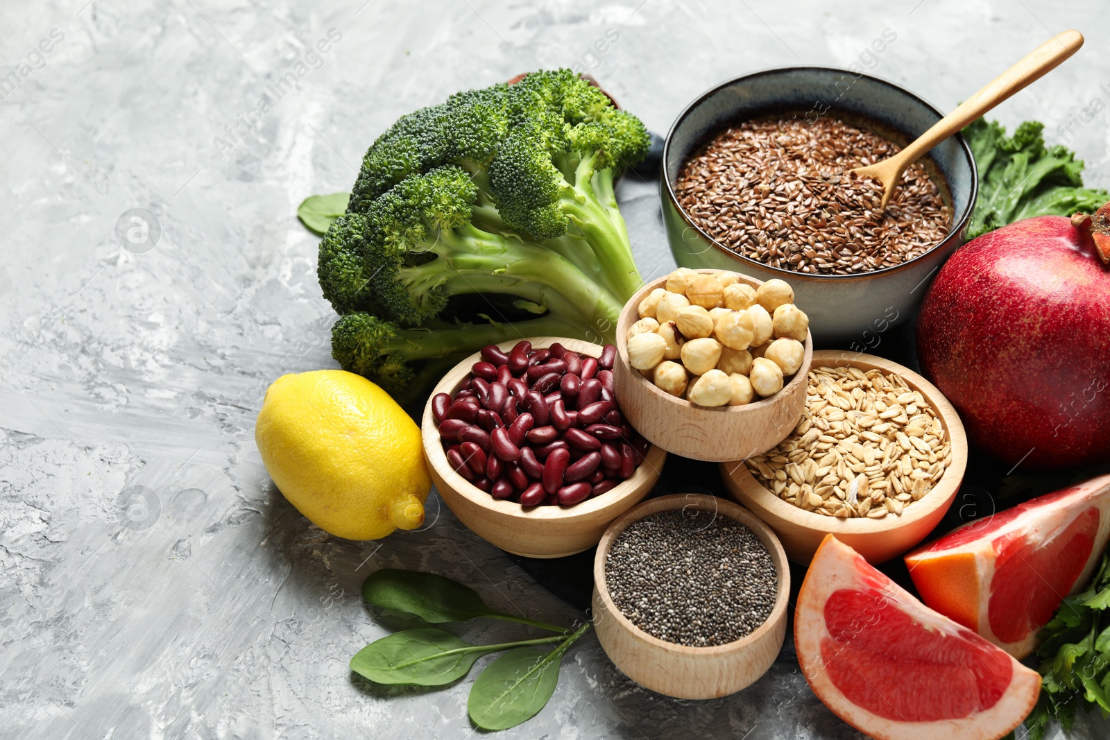 Photo of Different superfood products on grey textured table