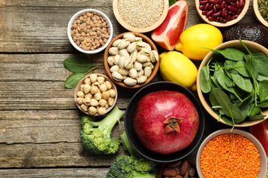 Photo of Different superfood products on wooden table, flat lay