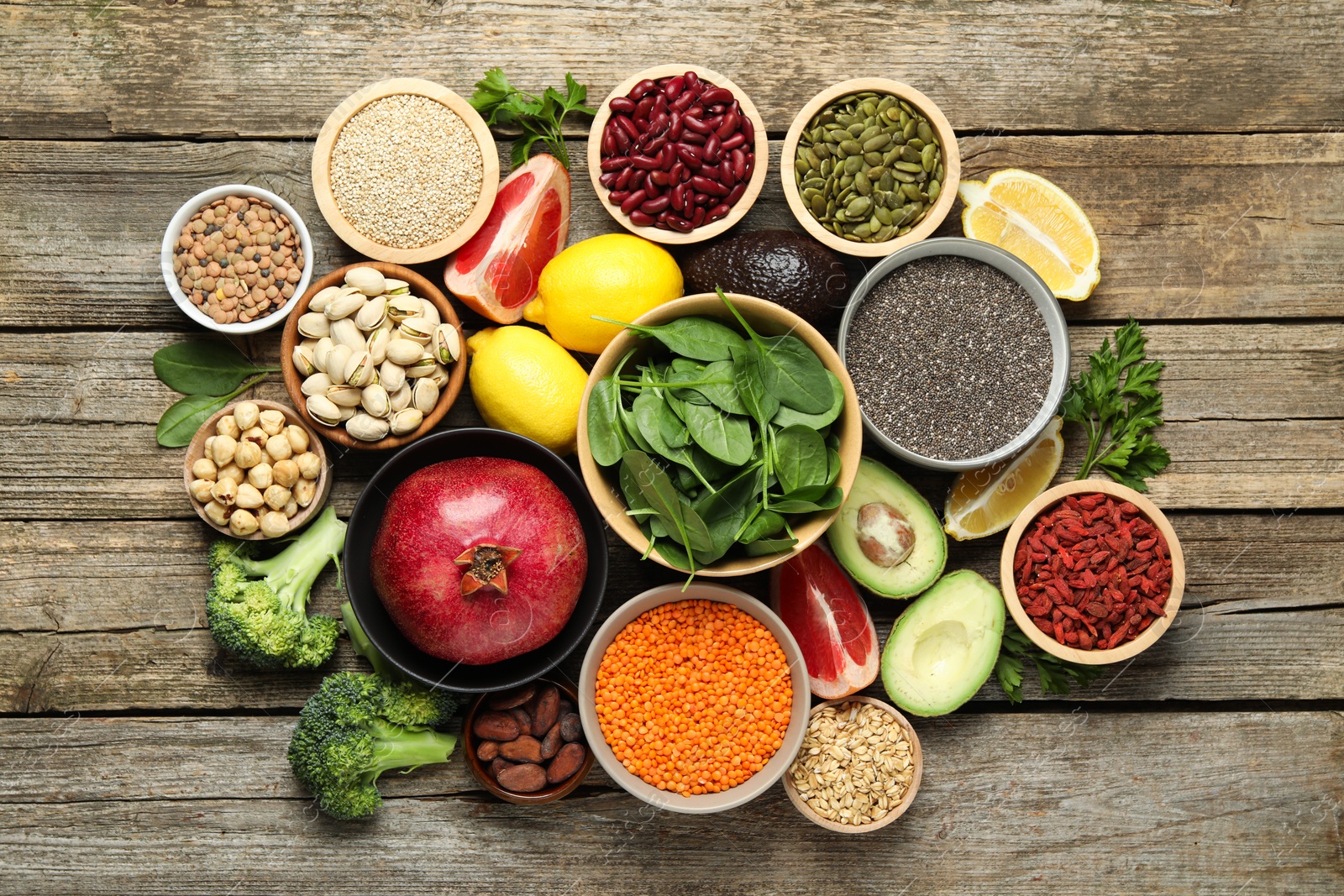 Photo of Different superfood products on wooden table, flat lay