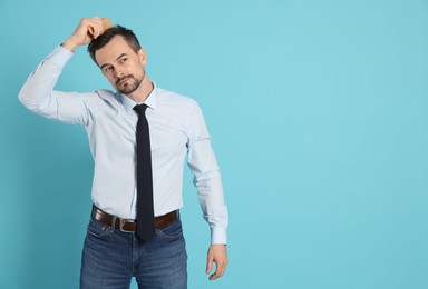 Photo of Handsome man stylish his hair with comb on light blue background