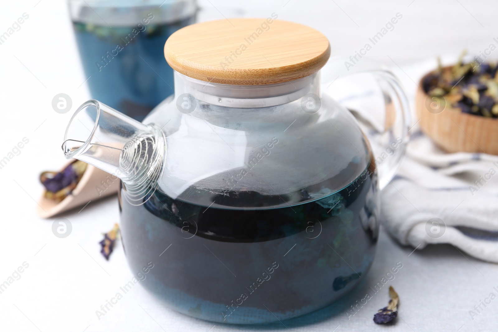 Delicious butterfly pea flower tea on white table, closeup Photo of Delicious butterfly pea flower tea on white table, closeup