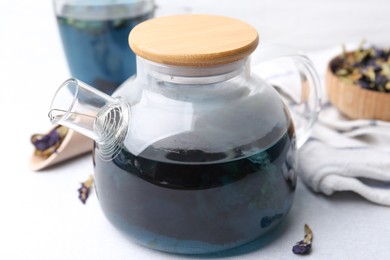 Photo of Delicious butterfly pea flower tea on white table, closeup