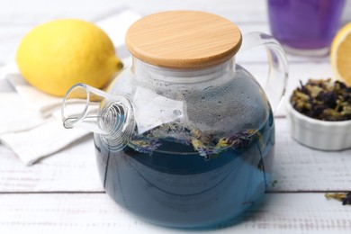 Delicious butterfly pea flower tea on wooden table, closeup