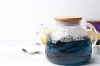 Delicious butterfly pea flower tea on wooden table against white background. Space for text