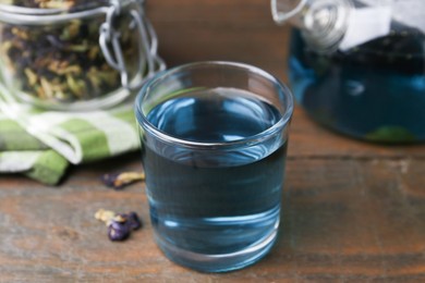 Delicious butterfly pea flower tea on wooden table, closeup