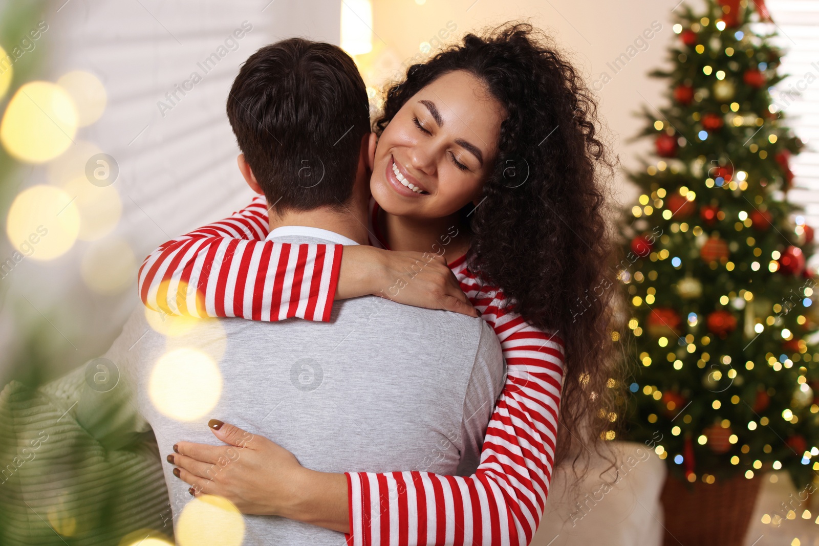 Photo of Happy couple hugging at home. Christmas celebration