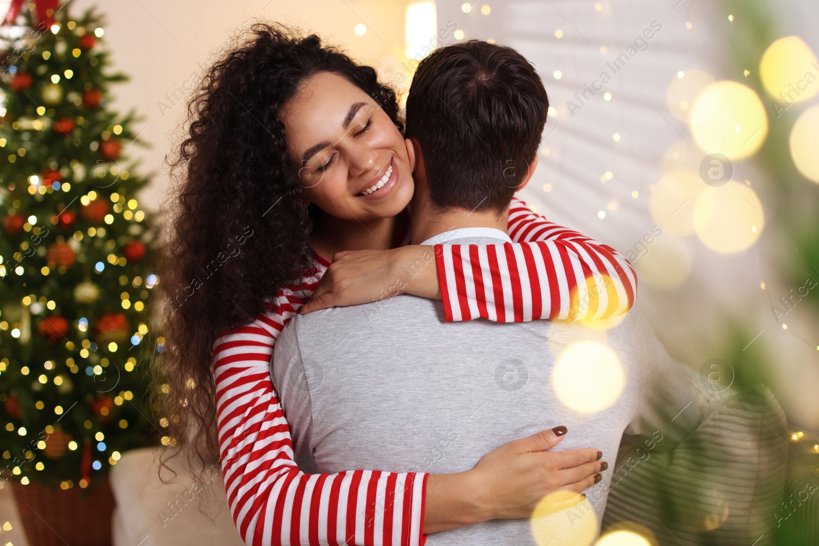 Photo of Happy couple hugging at home. Christmas celebration