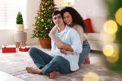 Photo of Happy couple spending time together at home. Christmas celebration