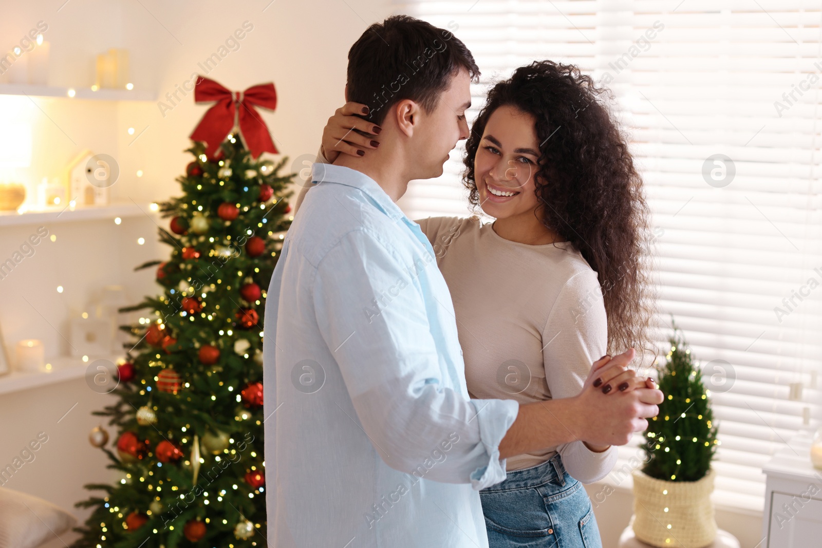 Photo of Happy couple dancing together at home. Christmas celebration