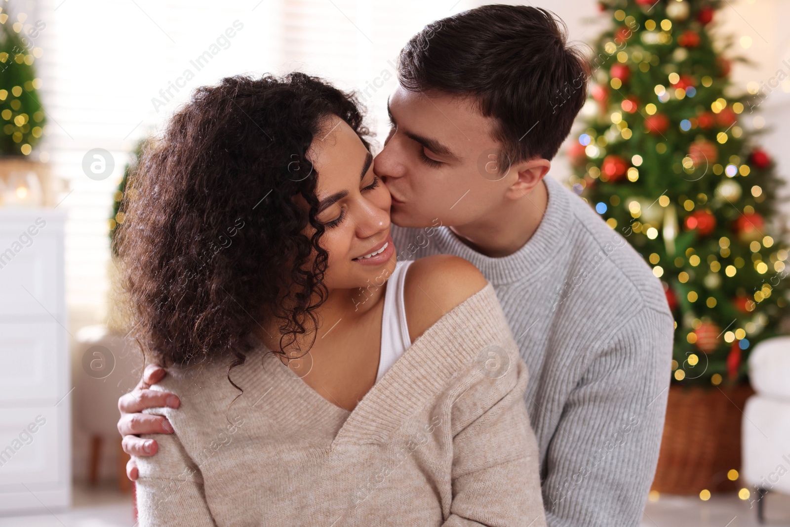 Photo of Happy couple spending time together at home. Christmas celebration