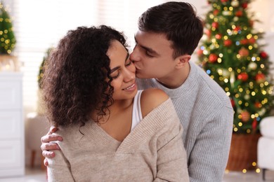 Photo of Happy couple spending time together at home. Christmas celebration