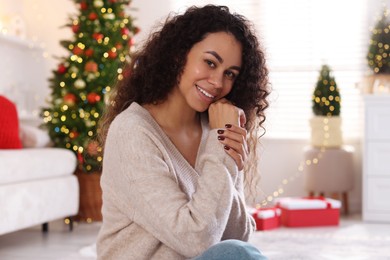 Photo of Portrait of beautiful young woman at home. Christmas celebration