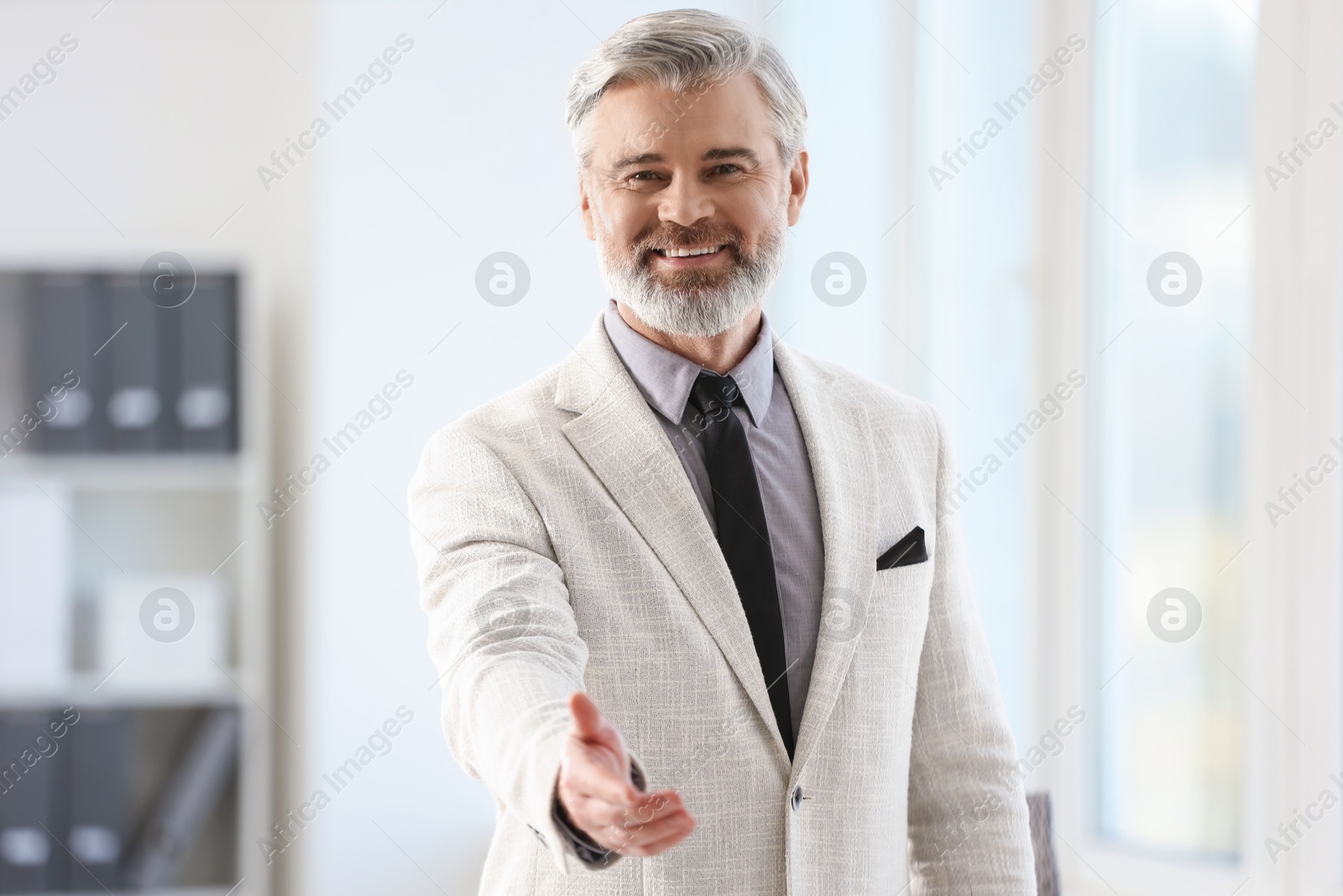 Photo of Portrait of happy banker in jacket indoors