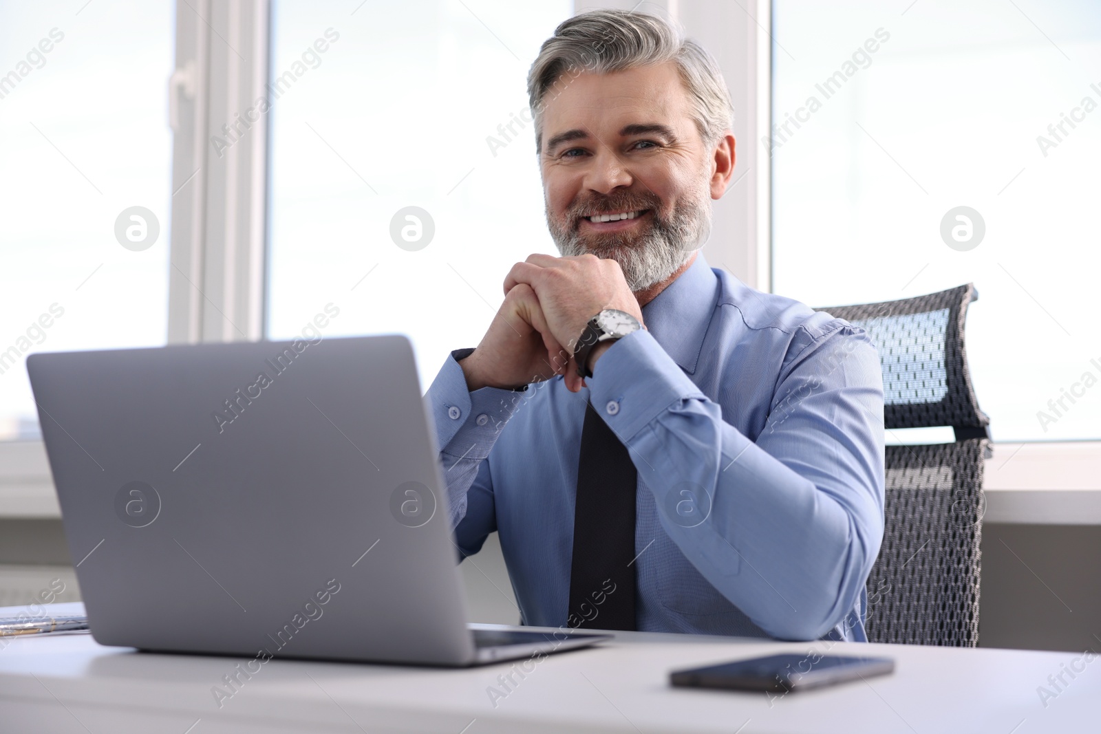 Photo of Portrait of banker at desk in office