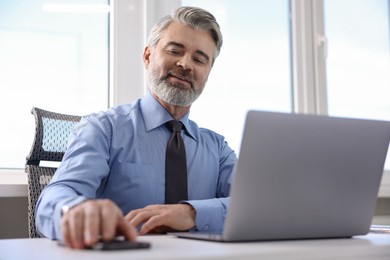 Photo of Banker with smartphone at desk in office