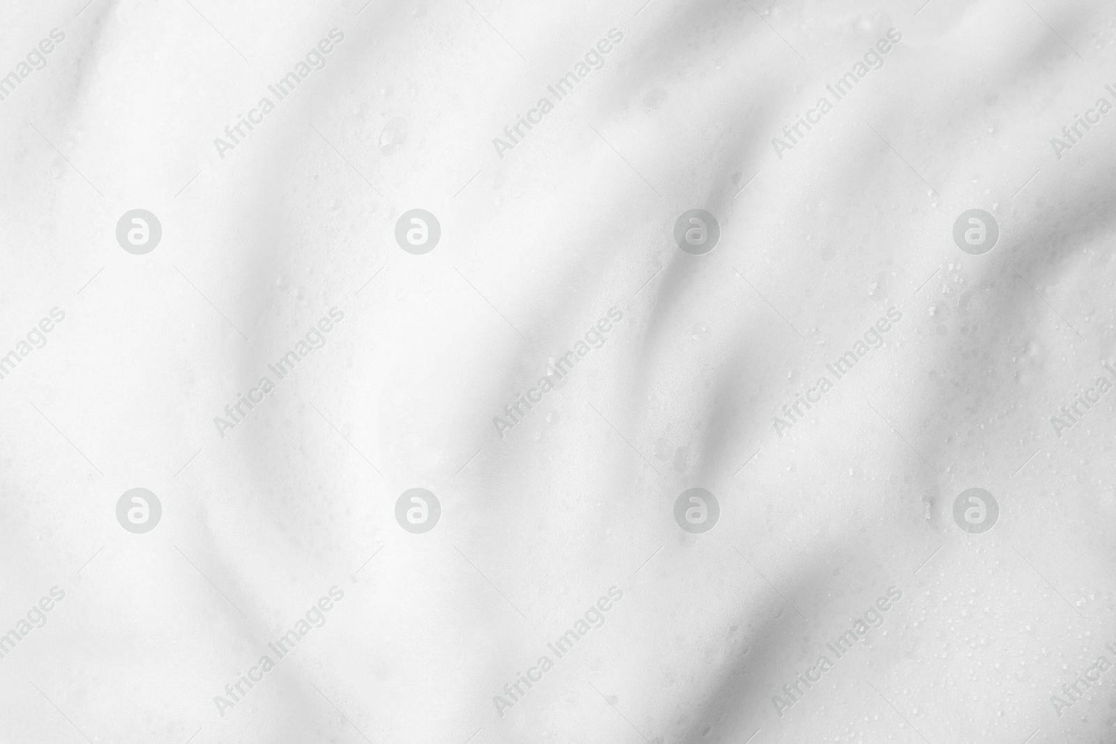 Photo of White fluffy foam as background, top view