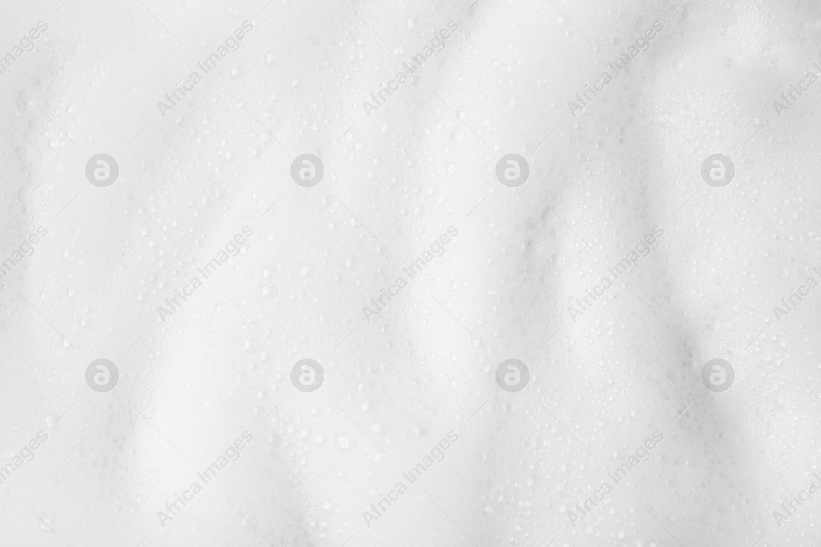 Photo of White fluffy foam as background, top view