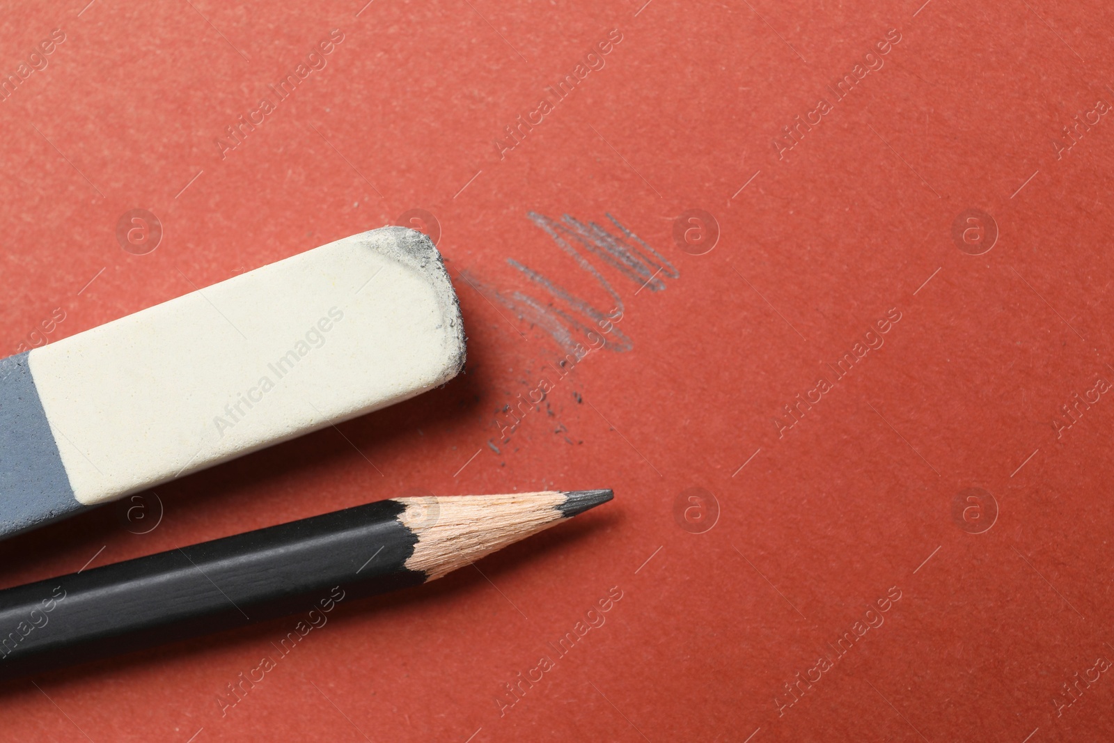 Photo of Eraser and pencil on brown background, flat lay. Space for text