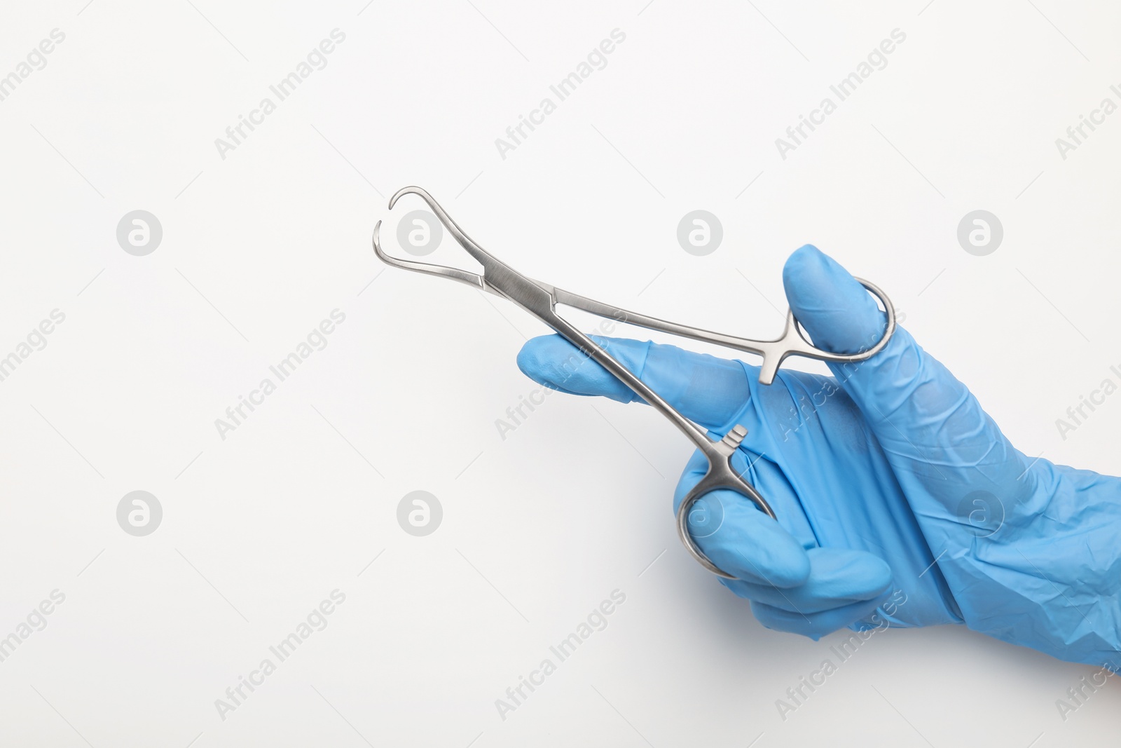 Photo of Doctor holding backhaus forceps on light background, top view with space for text. Surgical tool