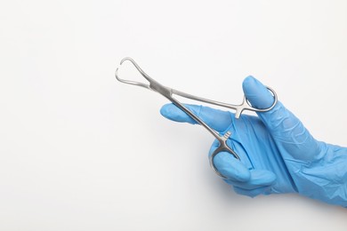 Photo of Doctor holding backhaus forceps on light background, top view with space for text. Surgical tool