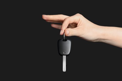 Photo of Woman with car key on black background, closeup. Space for text