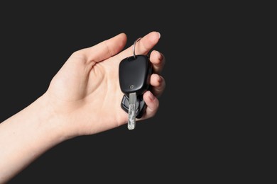 Photo of Woman with car keys on black background, closeup. Space for text