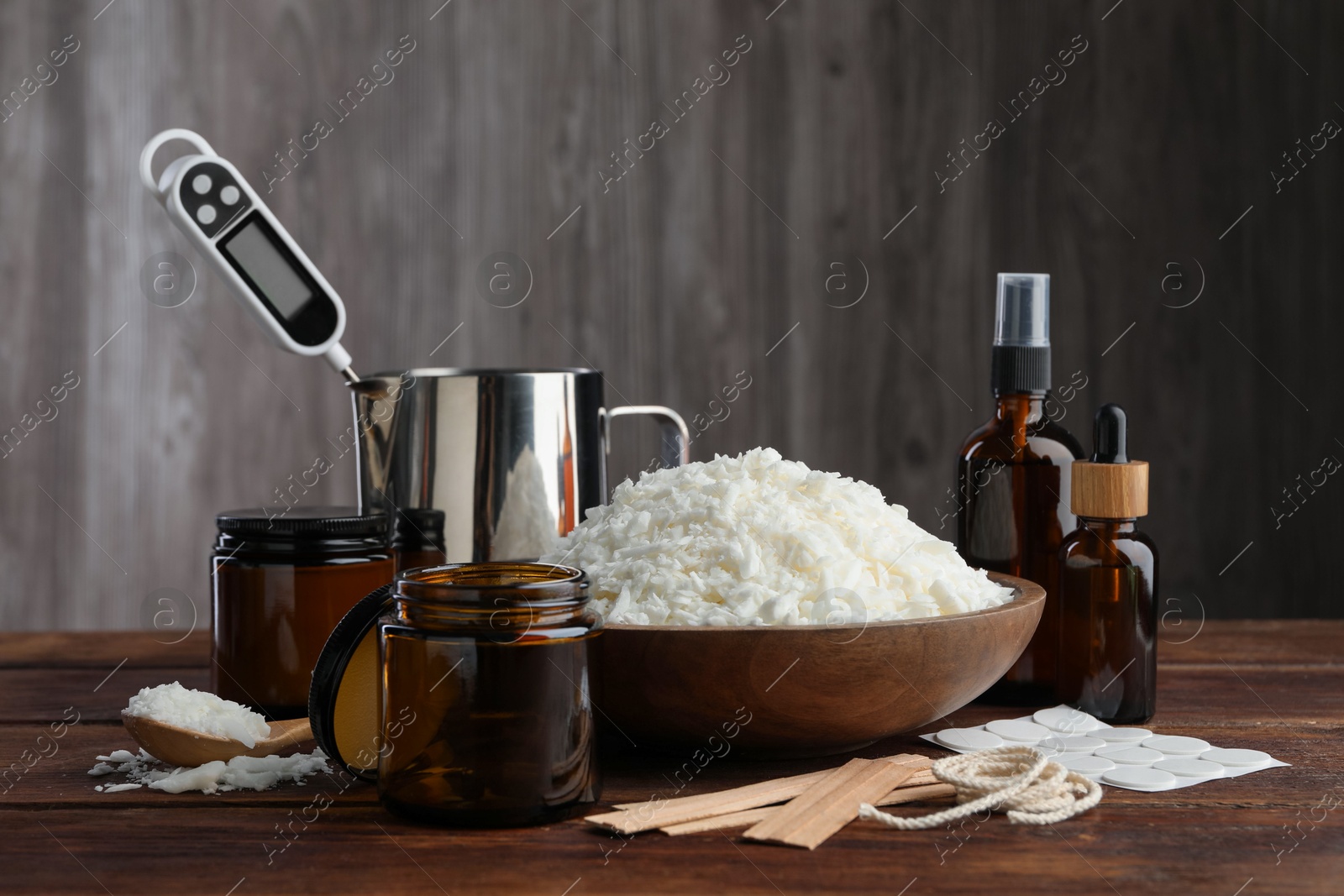 Photo of Soy wax and other supplies for making candles on wooden table