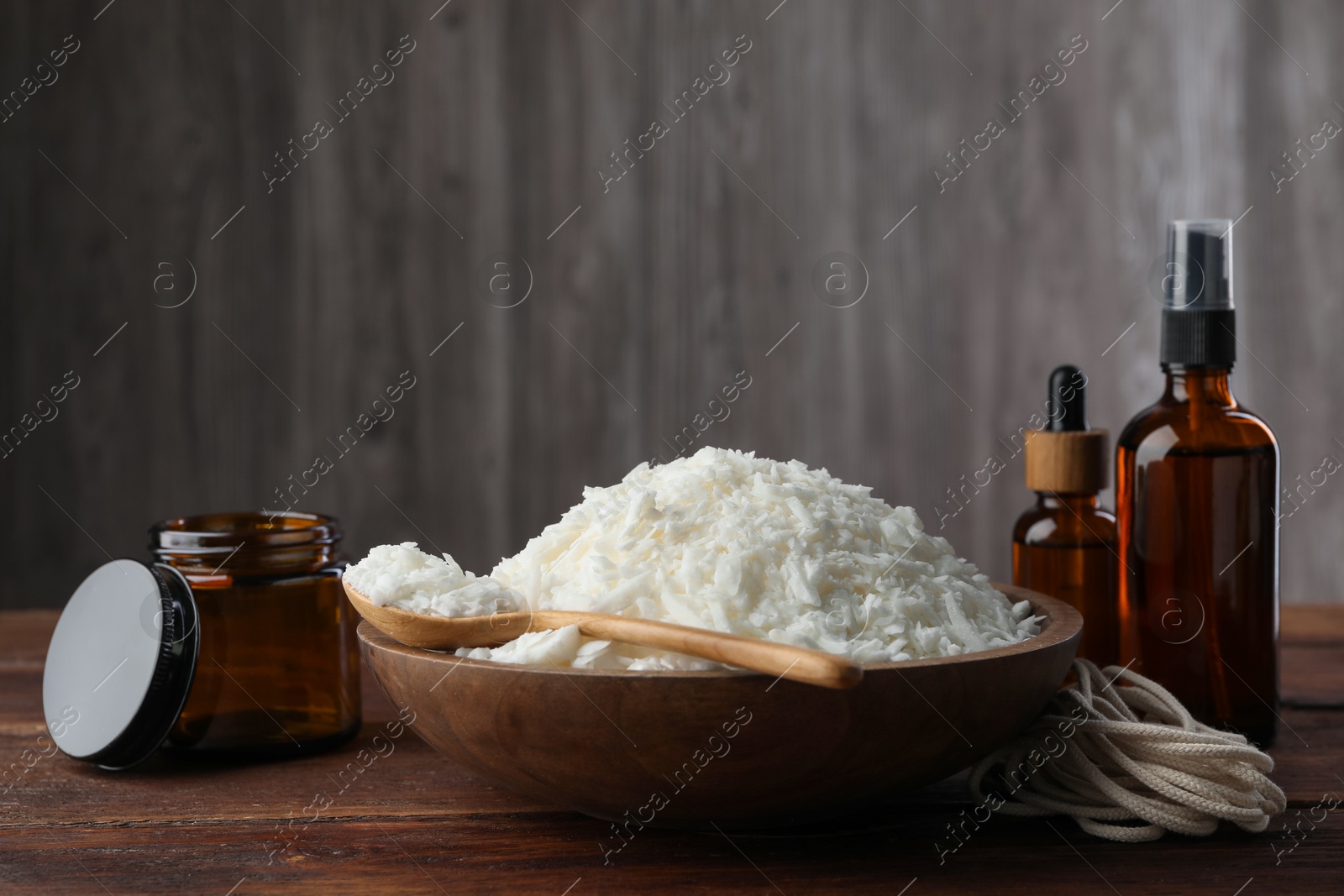 Photo of Soy wax and other supplies for making candles on wooden table