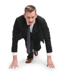 Photo of Businessman in starting position for run ready for competition on white background