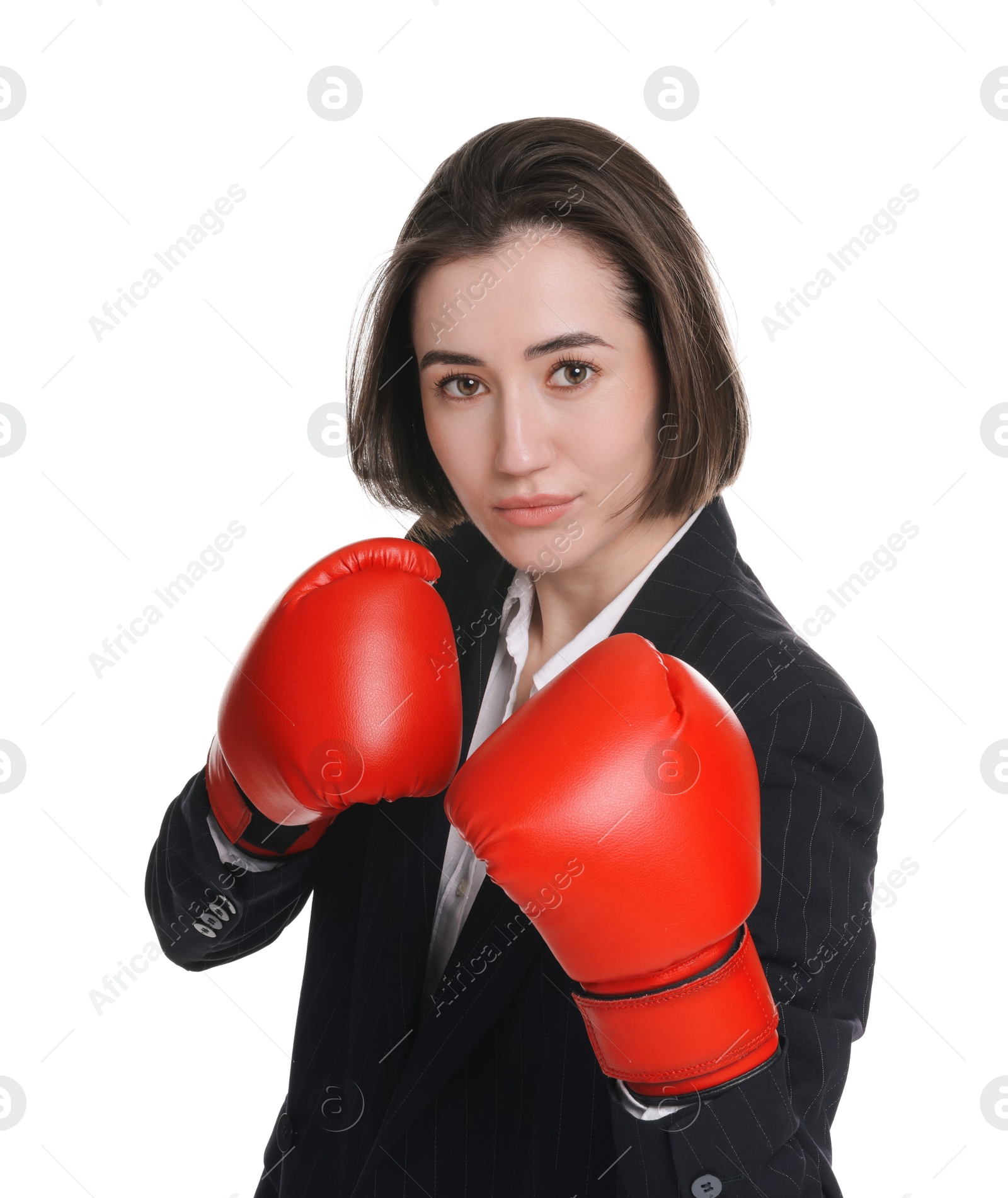 Photo of Competition. Businesswoman in suit wearing boxing gloves on white background