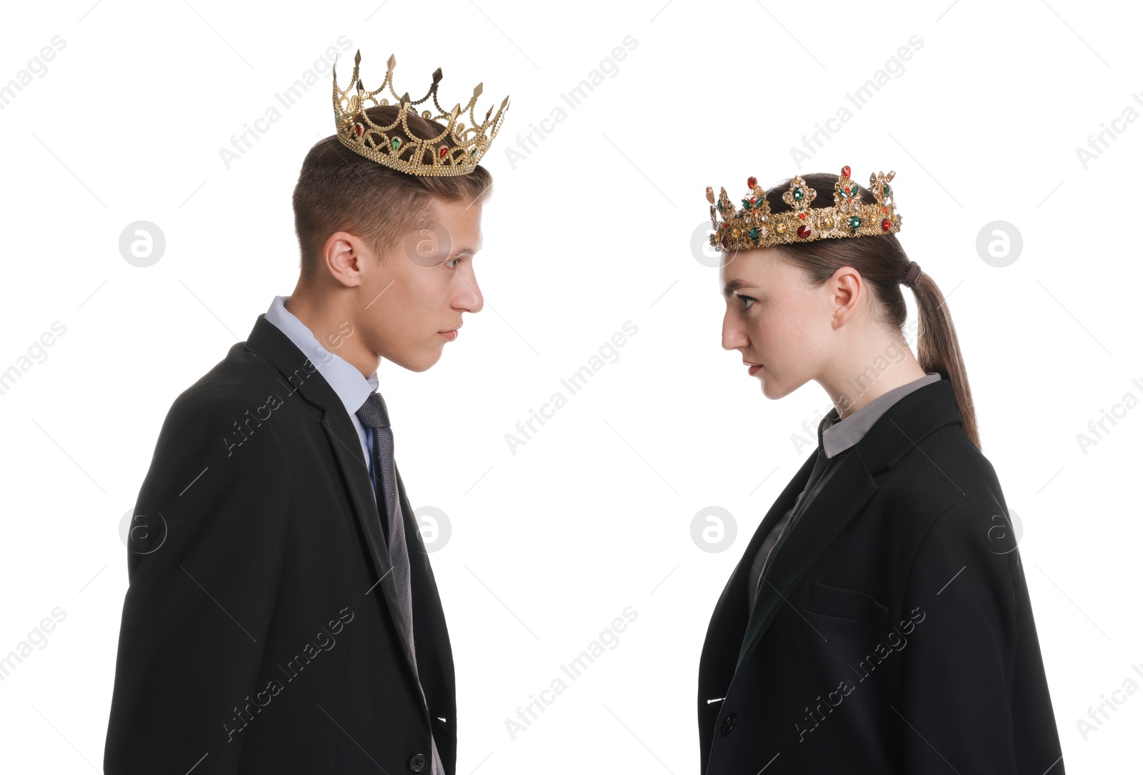 Photo of Business competition. Colleagues in golden crowns looking at each other on white background