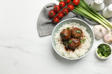 Photo of Delicious rice with meatballs, sauce and green onions on white marble table, flat lay. Space for text