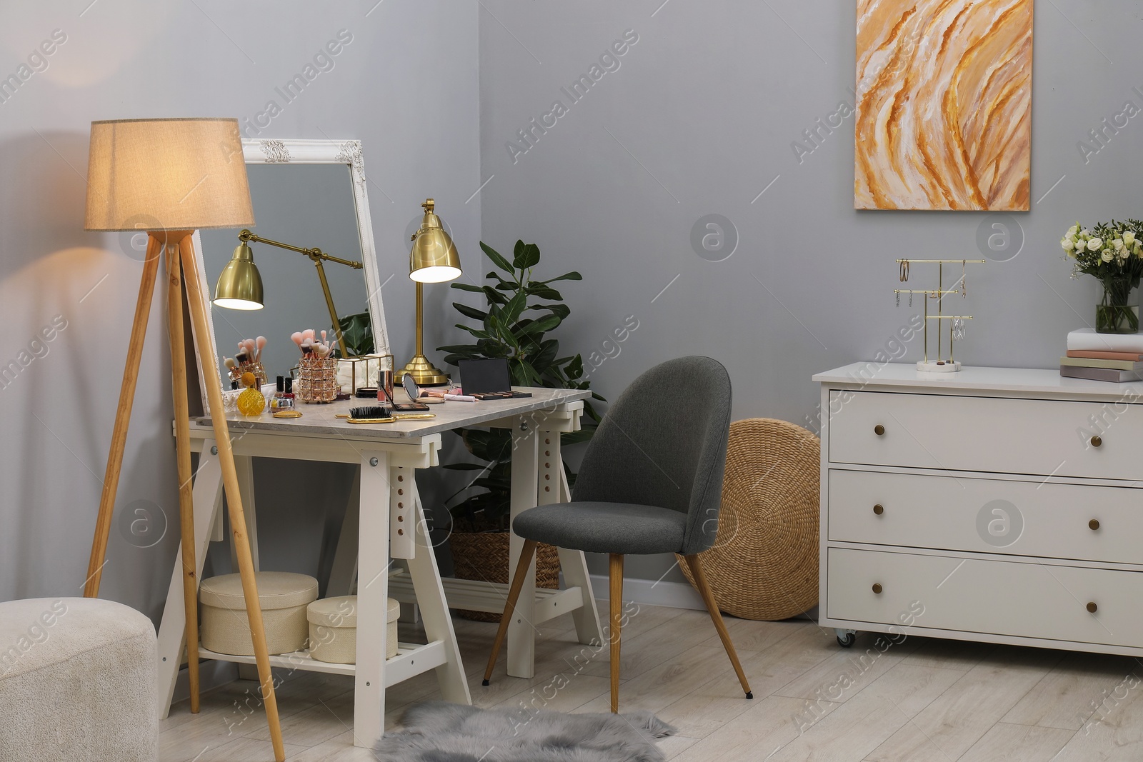 Photo of Makeup room. Mirror, dressing table, different beauty products and chair indoors