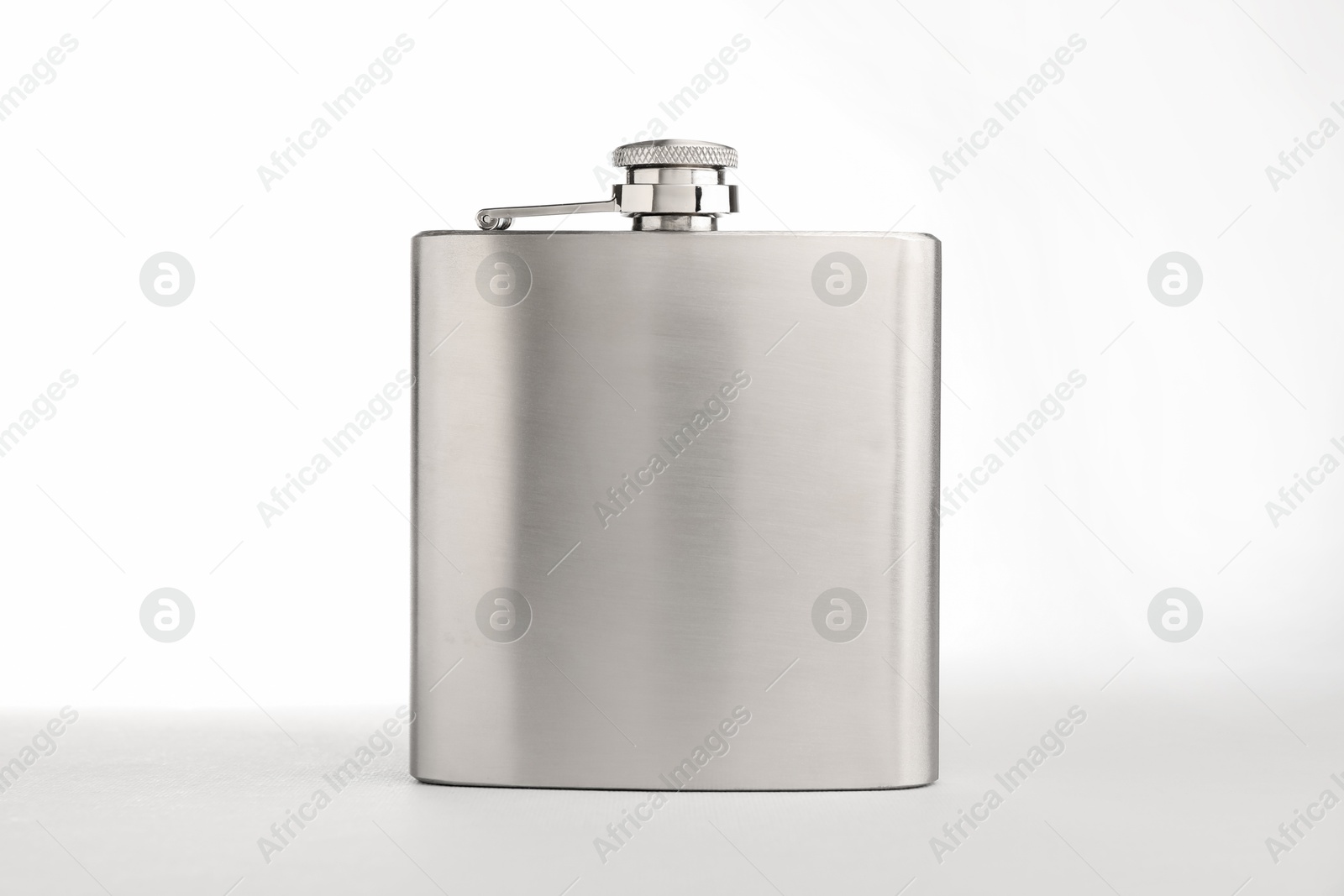 Photo of One hip flask on light table against white background