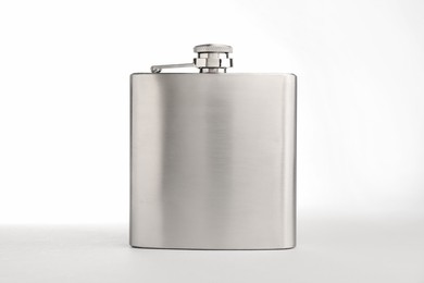 Photo of One hip flask on light table against white background