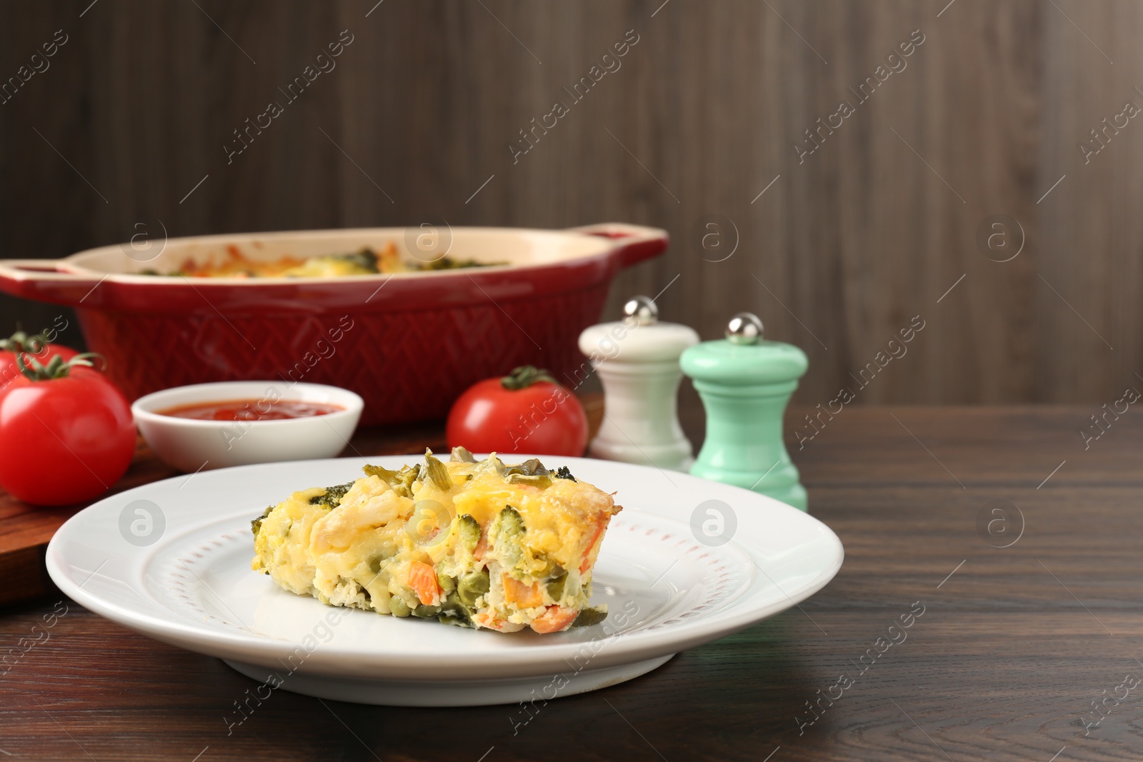 Photo of Tasty vegetable casserole on wooden table, closeup