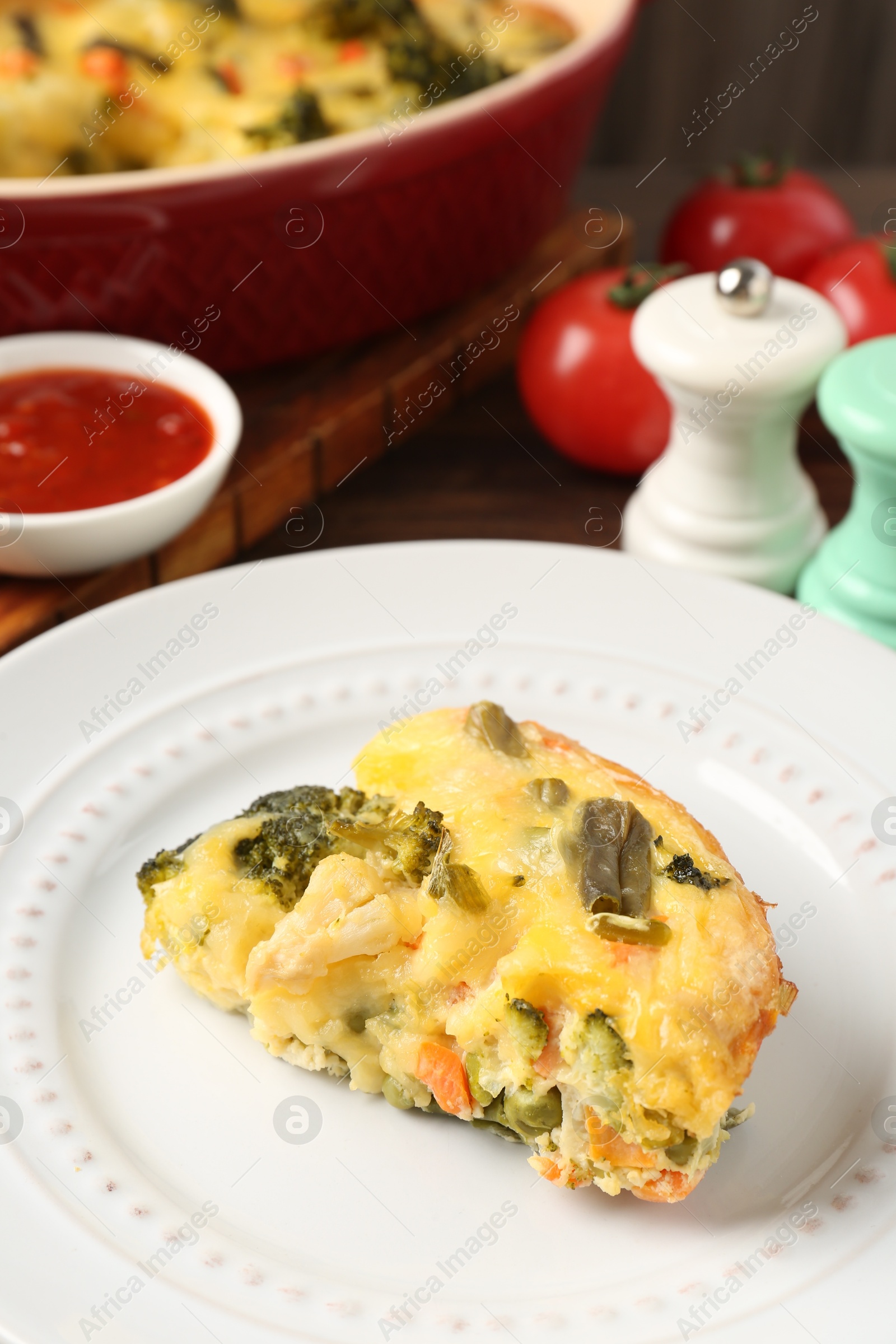 Photo of Piece of tasty vegetable casserole on table, closeup