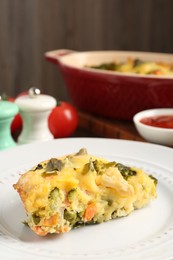 Photo of Piece of tasty vegetable casserole on table, closeup