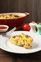 Photo of Tasty vegetable casserole on wooden table, closeup