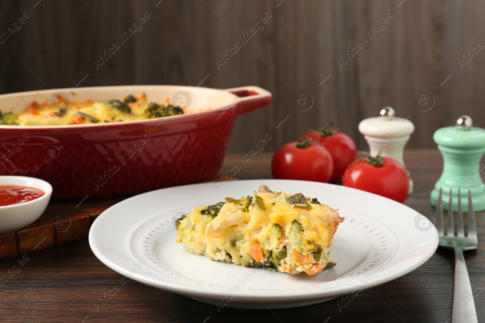 Photo of Piece of tasty vegetable casserole on wooden table, closeup