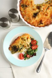 Photo of Tasty vegetable casserole and salad on white wooden table, flat lay