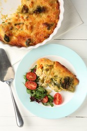 Photo of Tasty vegetable casserole and salad on white wooden table, flat lay