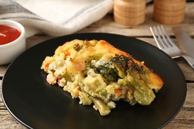 Photo of Tasty vegetable casserole on wooden table, closeup