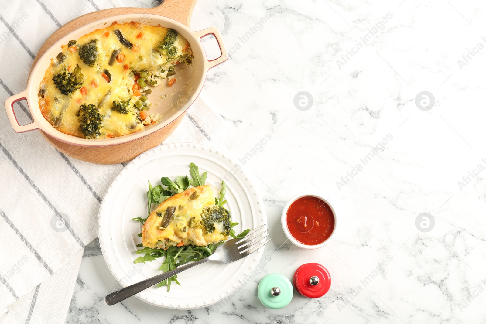 Photo of Tasty vegetable casserole served on white marble table, flat lay. Space for text