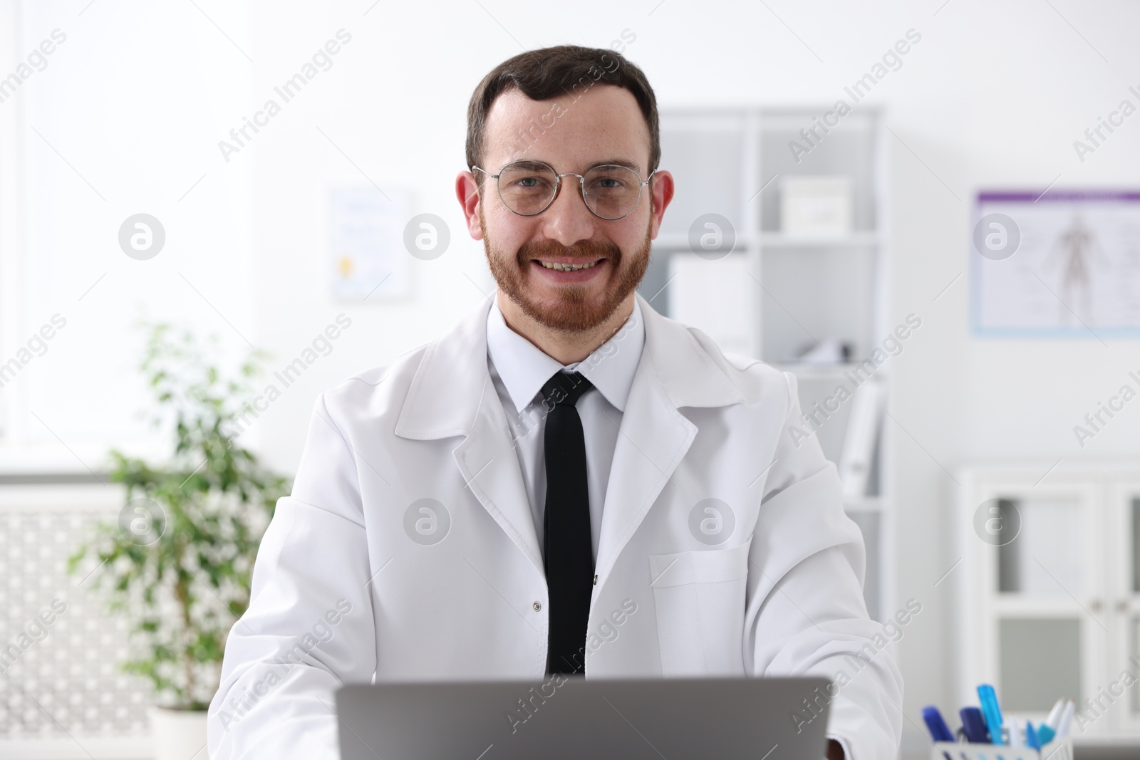 Photo of Portrait of professional doctor wearing white coat in hospital