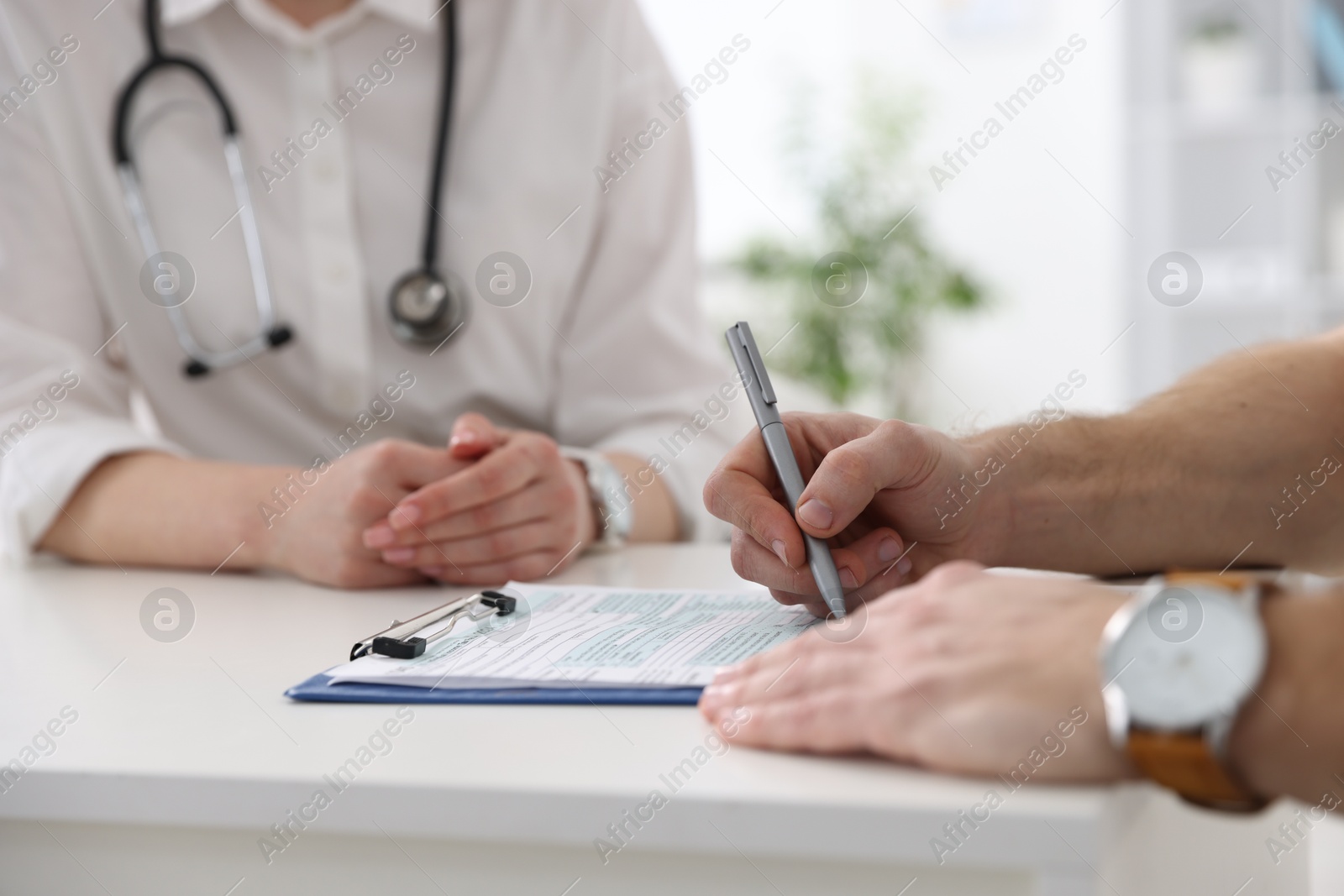 Photo of Man having appointment with doctor in hospital, closeup