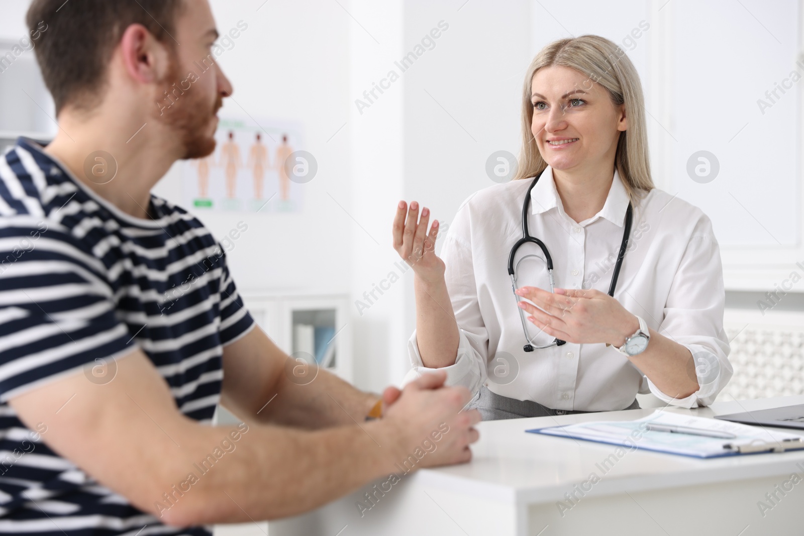 Photo of Man having appointment with doctor in hospital