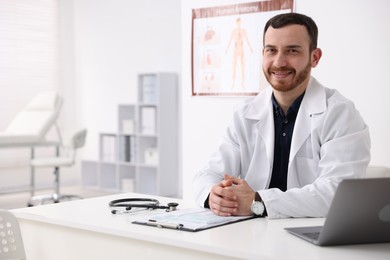 Photo of Professional doctor working at desk in hospital. Space for text