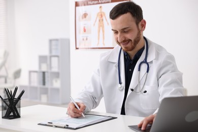 Photo of Professional doctor working at desk in hospital. Space for text